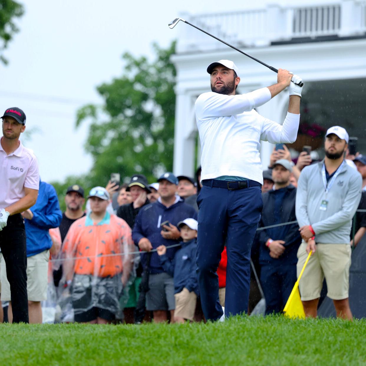 Scottie Scheffler hits an iron on tee box.JPG